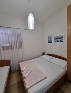 Postel nebo postele na pokoji v ubytování Apartmani Marić