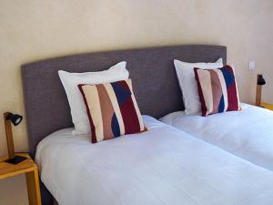 two beds sitting next to each other in a room at Le Moulin du Paroy in Serres