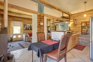 a dining room with a table and a kitchen at Pet-Friendly and Secluded Regina Cabin! in Regina