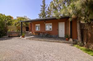 a small orange house with a table and a tree at VV Finca El Toscalito in Arona +38 photos