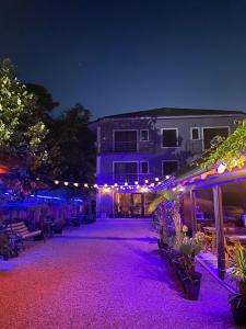 a patio with purple lights in front of a building at Casa Blanca Costinesti in Schitul