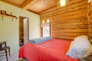 a bedroom with a bed in a log cabin at Pet-Friendly and Secluded Regina Cabin! in Regina