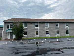 ein Gebäude mit einem Parkplatz davor in der Unterkunft Whalers Inn and Suites in New Bedford