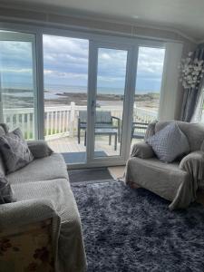a living room with a view of the ocean at Amazing holiday home with sea views in Newcastle upon Tyne