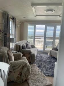 a living room with two beds and a view of the ocean at Amazing holiday home with sea views in Newcastle upon Tyne