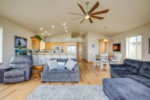 a living room with two couches and a kitchen at Gold Beach Retreat Private Hot Tub and Ocean Views! in Gold Beach