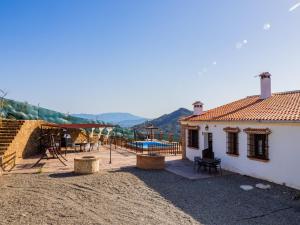 een achtertuin van een huis met een speeltuin bij Cubo's The Secret Almogia Mountain View in Málaga