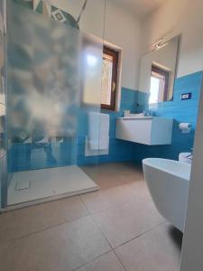 ein Bad mit einer Dusche, einem WC und einem Waschbecken in der Unterkunft Alma Ruia apartments in Stintino