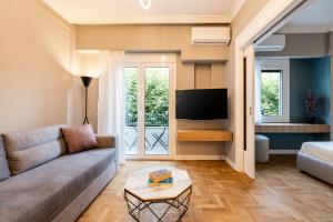 a living room with a couch and a tv at Frinichou 18 by Athens Concept Residences in Athens +11 photos