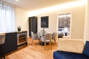 a living room with a table and chairs and a couch at Nuova Cafe' Suite in Salice Terme