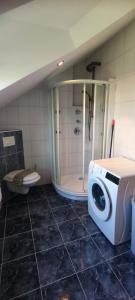 a bathroom with a shower and a washing machine at Panoramic spacious 3 bedroom apartment in Sumartin +18 photos