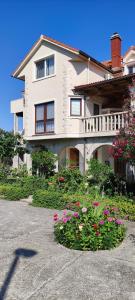 a large house with flowers in front of it at Panoramic spacious 3 bedroom apartment in Sumartin