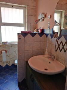 a bathroom with a sink and a mirror at Casita Solemar direkt am Atlantik in Calheta Do Maio