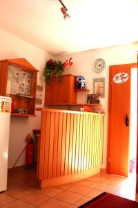 
a kitchen with a refrigerator, stove, and cabinets at Pension Feiken in Wesenufer

