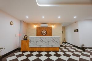 a lobby with a reception desk and a checkered floor at Revaas Lake View Boutique Stay in Udaipur +74 photos