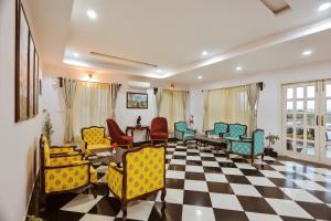 a living room with chairs and a checkerboard floor at Revaas Lake View Boutique Hotel in Udaipur