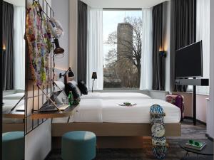 a hotel room with a bed and a window at Moxy Belgrade in Belgrade