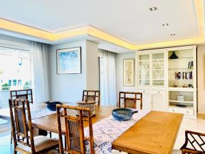 a dining room with a wooden table and chairs at SUPERIOR 3 bedroom MARBELLA center close to beach in Marbella