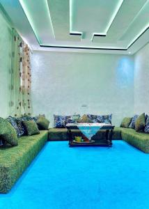 a living room with a couch and a table at Résidence Othmane in Dakhla