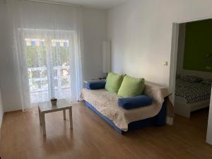 a living room with a couch and a table at Apartments Olea in Rab