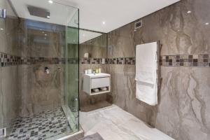 a bathroom with a shower and a sink at Ultra Luxury 3 Bedroom Address on Adderley in Cape Town