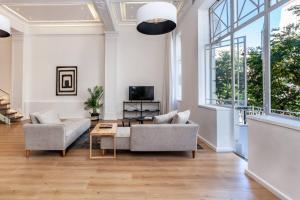 a living room with a couch and a table at Ultra Luxury 3 Bedroom Address on Adderley in Cape Town