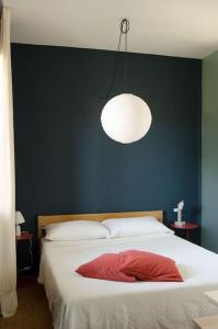 una camera con un grande letto con una parete blu di Beau Rivage - Suite Apartment in villa a SantʼArcangelo di Romagna
