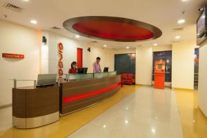 a lobby with two people at a reception desk at Ginger Mumbai Andheri (MIDC) in Mumbai