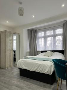 a bedroom with a large bed and a window at Inviting 2-Bed Apartment in Ilford in Ilford