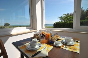 a table with a plate of food on a table in front of a window at Agriturismo Frontemare in Giulianova