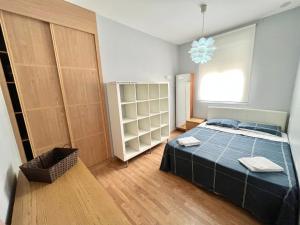 a bedroom with a bed and a large window at Triana 3 in Melilla