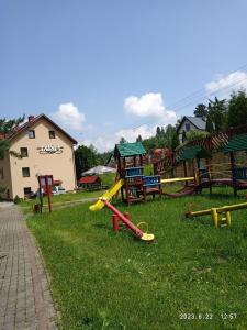 a bunch of playground equipment in the grass at Lusia in Wisła