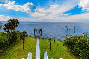 a walkway leading to the ocean with a view at Serenity On The Bay in Fairhope