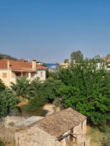 a view of a house with bushes and trees at Wooden Home in Ermioni +20 photos