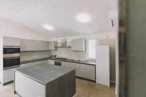 a kitchen with a island in the middle of it at Villa Nobile Cortona in Cortona