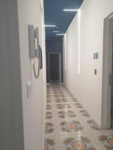 a hallway with a tile floor in a building at Dafne Home in Pompei