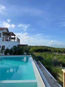 a swimming pool in front of a house at Altos de la Caobita in Barreras +48 photos