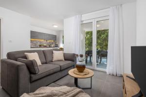 a living room with a couch and a table at Holiday Homes Oštro in Kraljevica