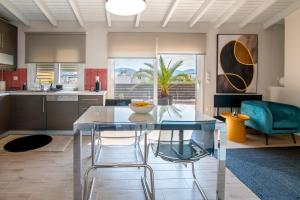 a kitchen with a glass table and chairs at fragoseco loft! Elegance & Luxury in Chalkida