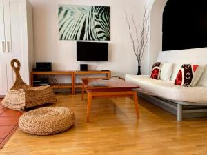 a living room with a couch and a table at Apartamentos Ondoloin in Vitoria-Gasteiz