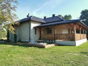 a house with a porch and a deck at Siedlisko pod Orzechem 