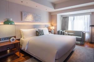Ένα ή περισσότερα κρεβάτια σε δωμάτιο στο Kilin Hotel, JiaoXi