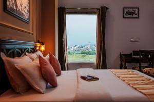 a bedroom with a large bed with a window at Revaas Lake View Boutique Hotel in Udaipur
