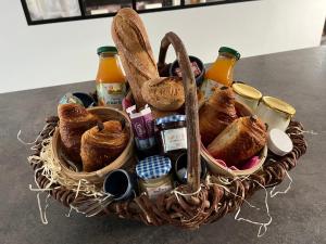 a basket of bread and other foods on a table at La fleur des marais in Batz-sur-Mer