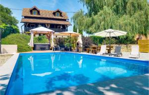 a swimming pool in front of a house at Gorgeous Home In Sveti Ivan Zelina With Jacuzzi in Sveti Ivan Zelina