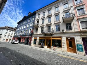 a building on a street next to a cobblestone street at Stay Swiss 1 bedroom apartments in old town in Porrentruy