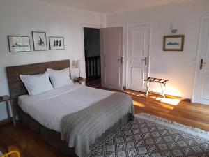 a bedroom with a large bed and a rug at Bed and Breakfast Saultchevreuil, au Mont Saint Michel in Villedieu-les-Poëles