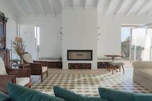 a living room with a couch and a fireplace at Amaria in Aljezur
