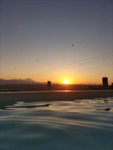 a sunset over a body of water with at il glicine in Chieti