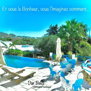 a patio with chairs and a swimming pool at DAR BELDI in Hammamet